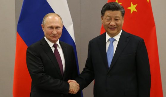 Russian President Vladimir Putin, left, shakes hands with Chinese President Xi Jinping during their bilateral meeting in Brasilia, Brazil, on Nov. 13, 2019.