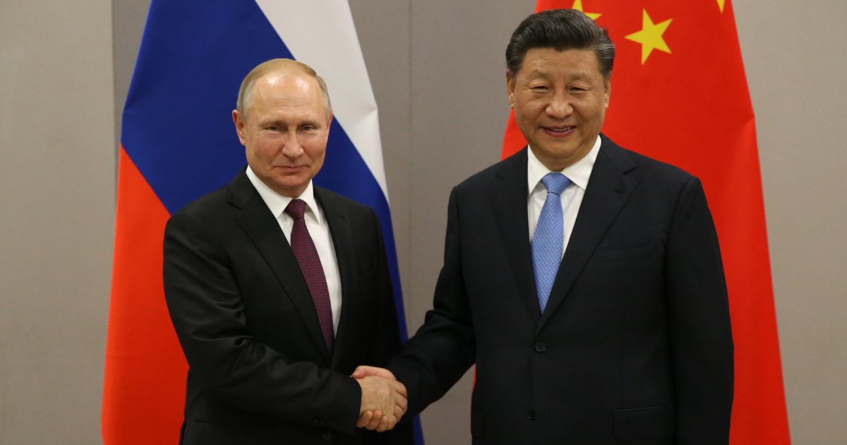 Russian President Vladimir Putin, left, shakes hands with Chinese President Xi Jinping during their bilateral meeting in Brasilia, Brazil, on Nov. 13, 2019.