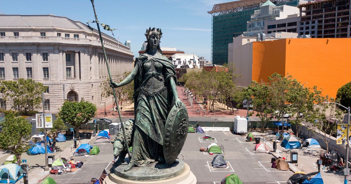 An aerial view shows a statue of Eureka, part of the Pioneer Monument, standing above squares painted on the ground to encourage homeless people to keep to social distancing at a city-sanctioned homeless encampment across from City Hall in San Francisco on May 22, 2020.