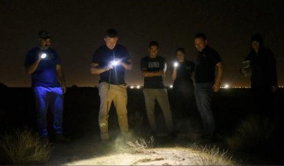 Troops and contractors at Ali Al Salem Air Base in Kuwait gather around a suspected hideout for scorpions as they hunt for the animals on Nov. 28.