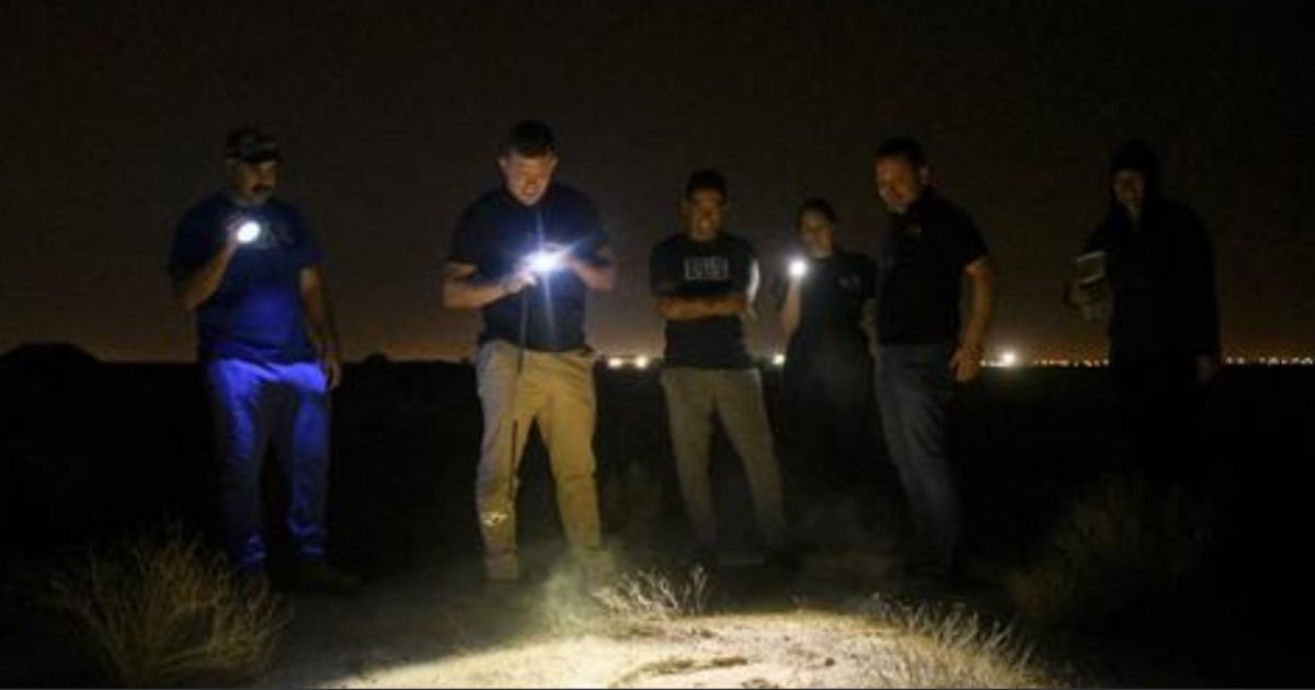 Troops and contractors at Ali Al Salem Air Base in Kuwait gather around a suspected hideout for scorpions as they hunt for the animals on Nov. 28.