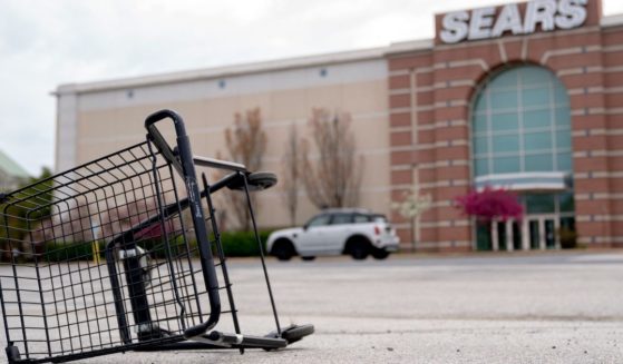A shopping cart sits tipped over in the parking lot of a Sears store in Wilmington, Delaware, on April 23.