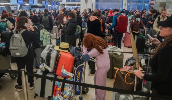 Southwest Airlines' passengers stand in lines during delays and cancellations at Laguardia Airport in New York City on Friday.