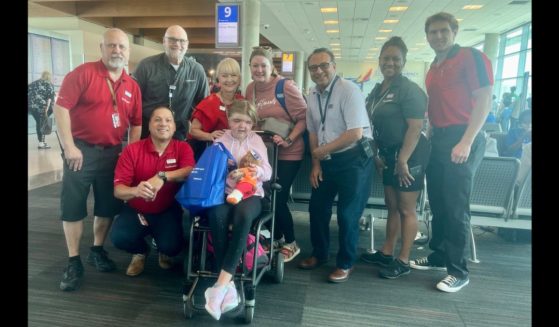 Southwest Airlines employees pose with Mary Cate Lynch.