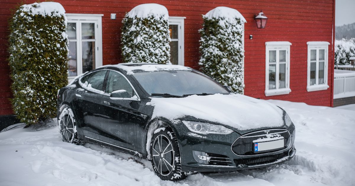 A Tesla Model S is parked in the snow next to a cottage in Tønsberg, Norway, on Feb. 19, 2021.