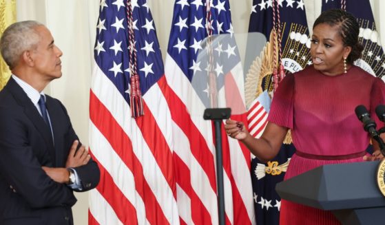 Barack Obama, left, listens as his wife Michelle Obama, right, delivers remarks during a ceremony to unveil their official White House portraits at the White House in Washington, D.C., on Sept. 7.