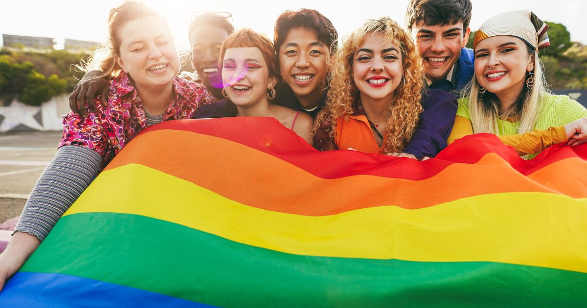 A group of minors hold the LGBT flag.