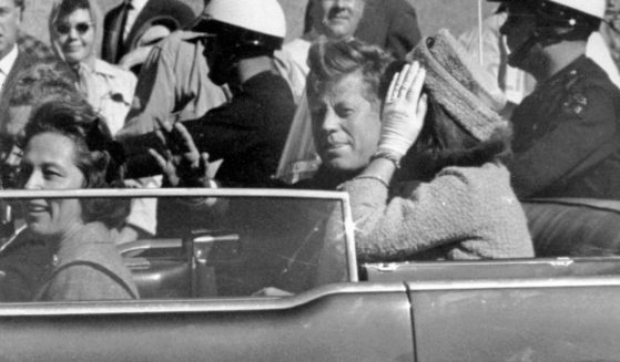 President John F. Kennedy waves from his car in a motorcade in Dallas before he was fatally shot on Nov. 22, 1963. Riding with Kennedy are First Lady Jacqueline Kennedy, right, Nellie Connally, second from left, and her husband, Texas Gov. John Connally, far left.