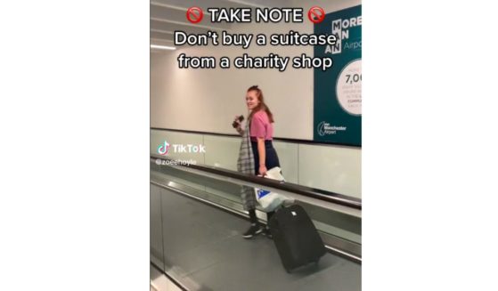A daughter wheels her suspicious suitcase at an airport -- presumably in Manchester, England -- last month.