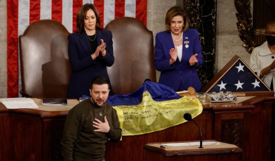 Ukraine President Volodymyr Zelenskyy thanks members of Congress after presenting a flag signed by members of the Ukrainian military to House Speaker Nancy Pelosi, right, and Vice President Kamala Harris during a joint meeting of Congress in the House Chamber of the U.S. Capitol in Washington on Wednesday.