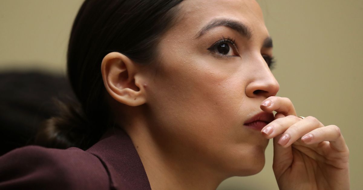 Rep. Alexandria Ocasio-Cortez (D-NY) listens to testimony by Michael Cohen, former attorney and fixer for President Donald Trump, before the House Oversight Committee on Capitol Hill Feb. 27, 2019, in Washington, D.C.