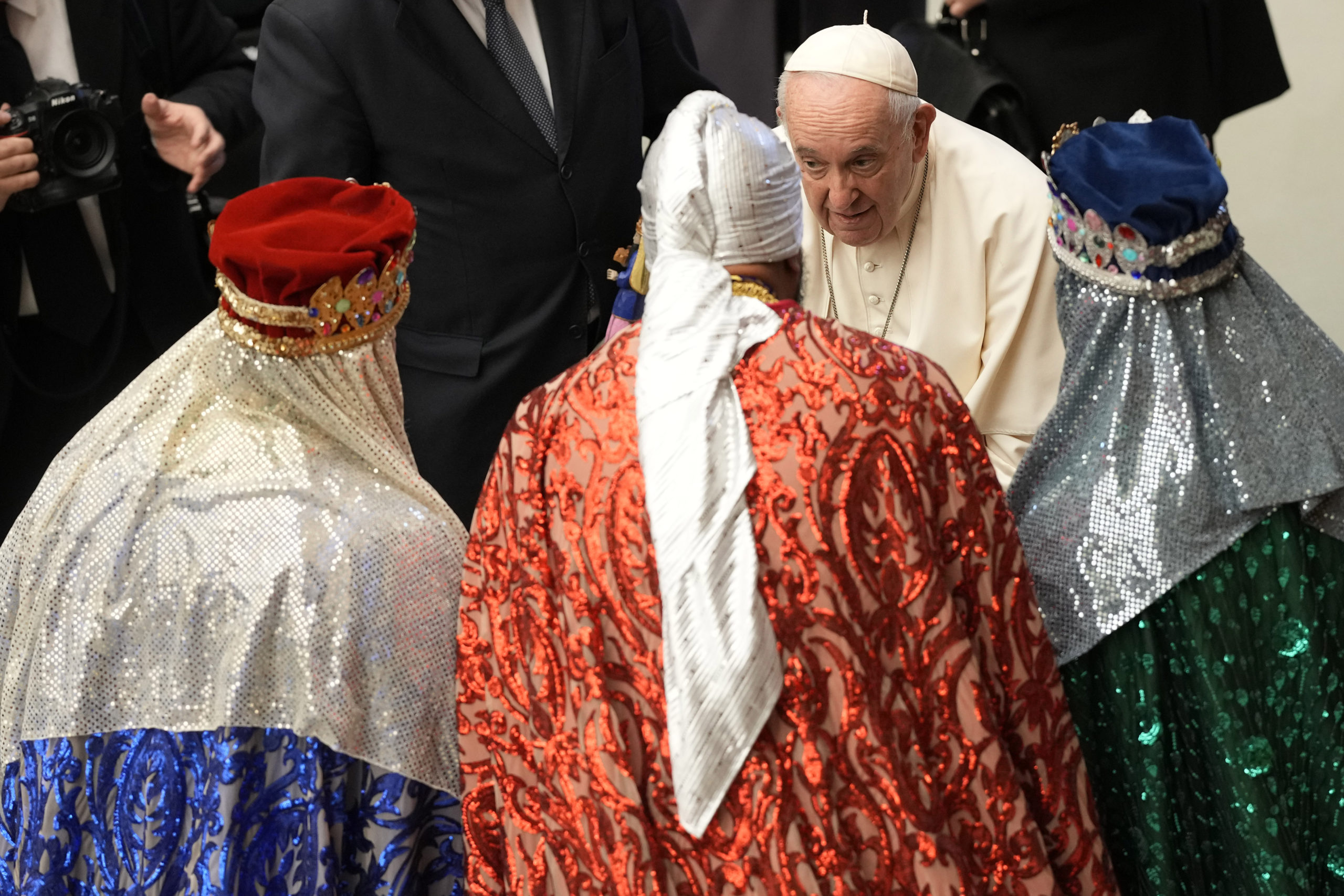 Pope Francis talks to men dressed as the three wise men at the end of his weekly general audience in the Paul VI Hall at the Vatican on Wednesday.