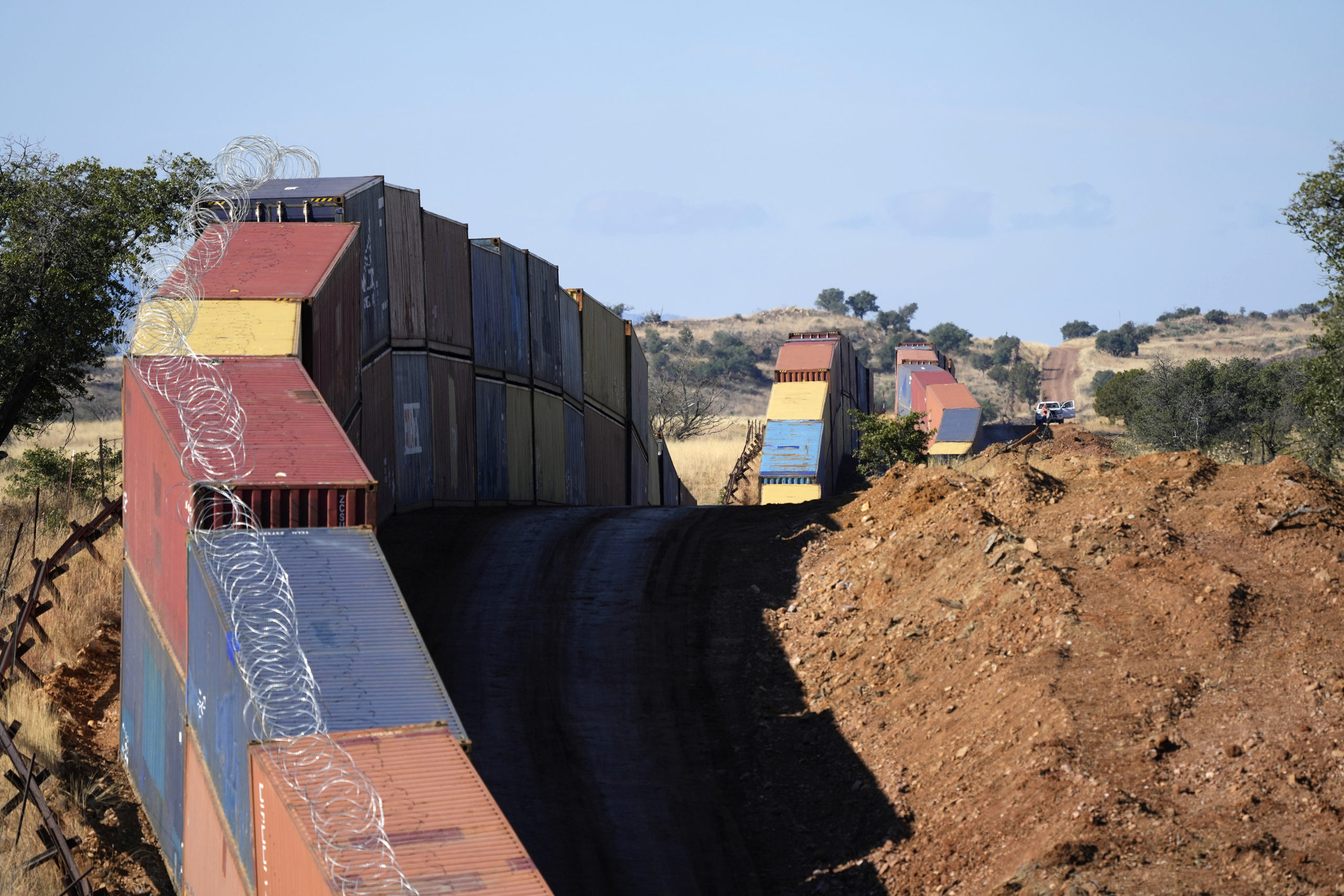 A long row of double-stacked shipping containers provide a new wall between the United States and Mexico in the remote section area of San Rafael Valley, Arizona, on Dec. 8.