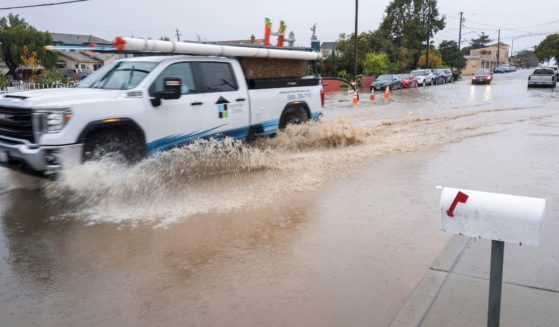 A truck drives through a flooded intersection in Salinas, California, on Tuesday.