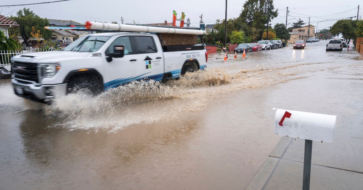 A truck drives through a flooded intersection in Salinas, California, on Tuesday.