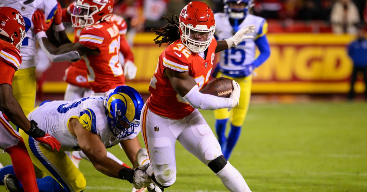 Kansas City Chiefs linebacker Nick Bolton (32) runs back an interception as Los Angeles Rams guard Oday Aboushi (63) tries to tackle him during the second half of an NFL football game on Nov. 27 in Kansas City, Missouri.