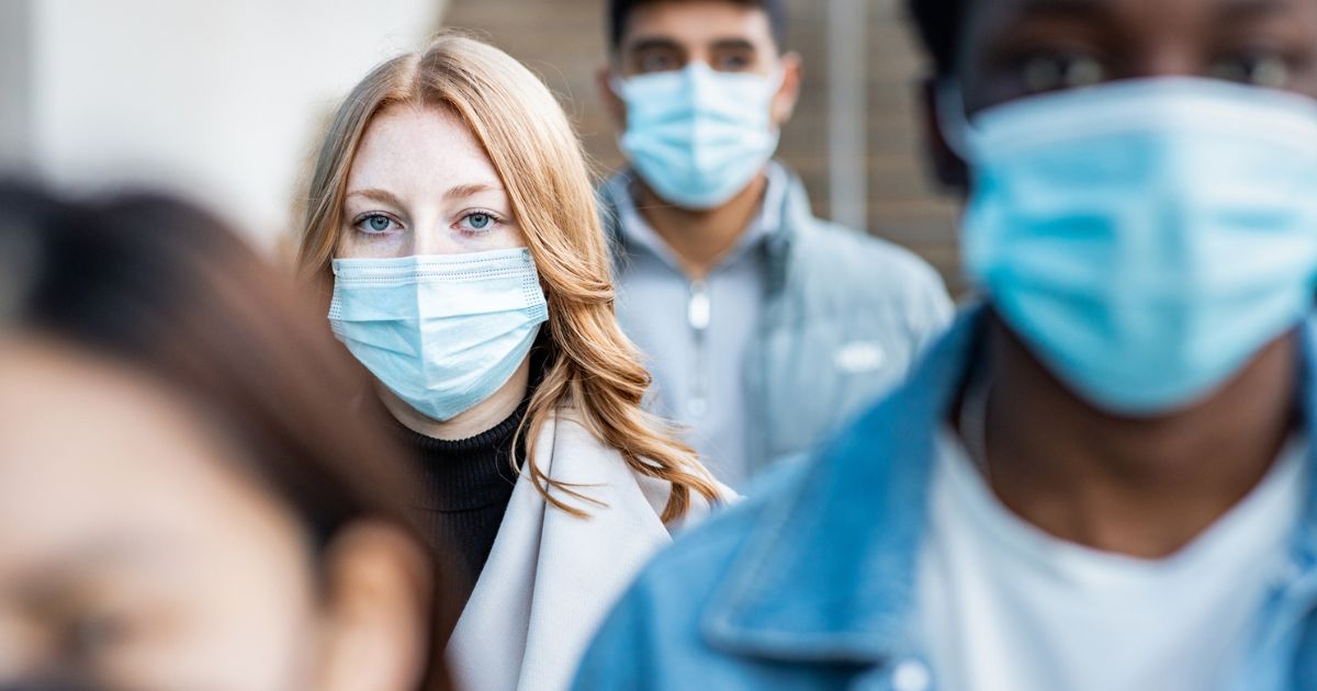 People wear masks in this stock image.