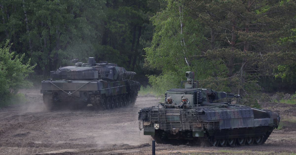 A Bundeswehr Leopard 2 A6 heavy tank (L) and a Puma mechanized infantry combat vehicle participate in a demonstration of capabilities by the Panzerlehrbrigade 9 tank training brigade on June 2, 2021 in Munster, Germany.