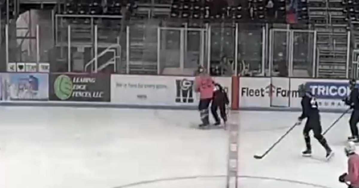 A male hockey player slams a female hockey player during a "transgender" game in Middleton, Wisconsin.