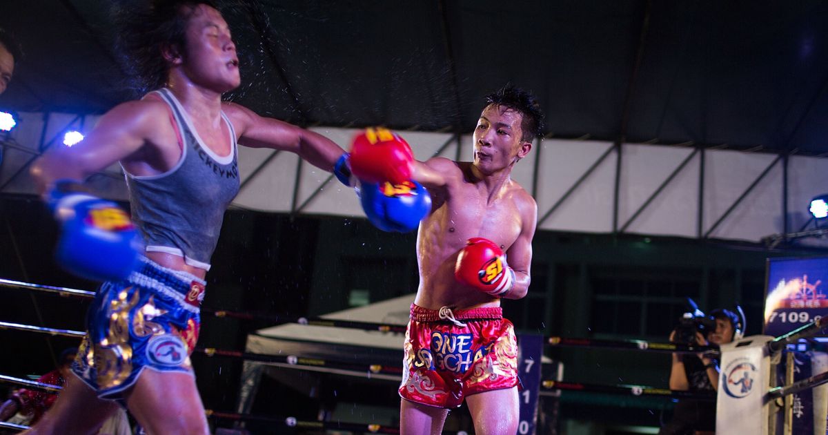 Somros "Rose" Pholjaroen, a transgender Muay Thai fighter, is punched by an opponent.