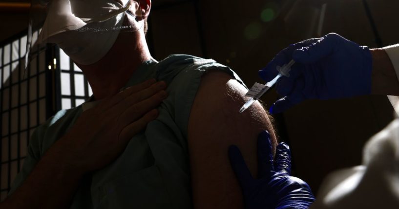 A man receives a dose of the Pfizer-BioNTech COVID-19 vaccine on Dec. 16, 2020, in Aurora, Colorado.