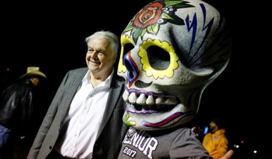 Nevada Gov. Steve Sisolak poses with a supporter wearing a Calavera, which is a representation of a human skull, at the Día De Muertos Camino al Mictlan festival at Freedom Park on Nov. 2 in Las Vegas.