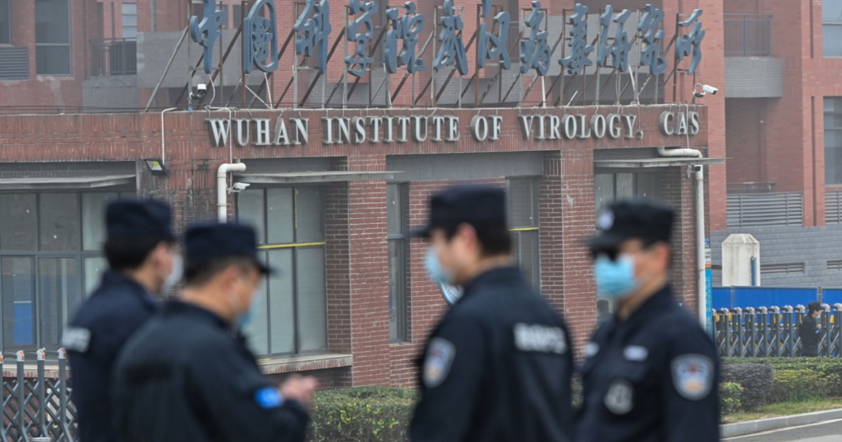 Security personnel stand guard outside the Wuhan Institute of Virology in Wuhan, China, in a February 2021 file photo.