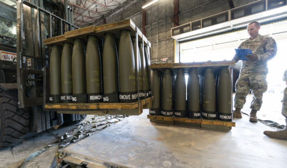 U.S. Air Force Staff Sgt. Cody Brown checks pallets of 155 mm shells bound for Ukraine on Dover Air Force Base, Delaware, on April 29, 2022.