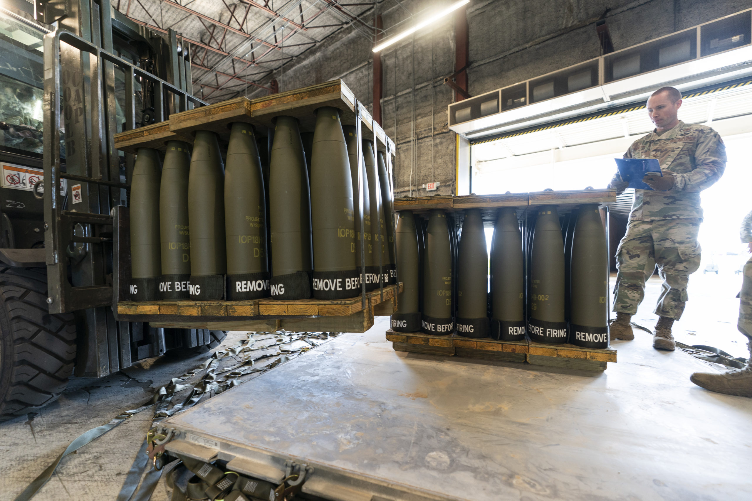 U.S. Air Force Staff Sgt. Cody Brown checks pallets of 155 mm shells bound for Ukraine on Dover Air Force Base, Delaware, on April 29, 2022.