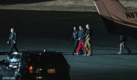 Bryan Kohberger is escorted by law enforcement after arriving at Pullman-Moscow Regional Airport in Pullman, Washington, on Thursday.