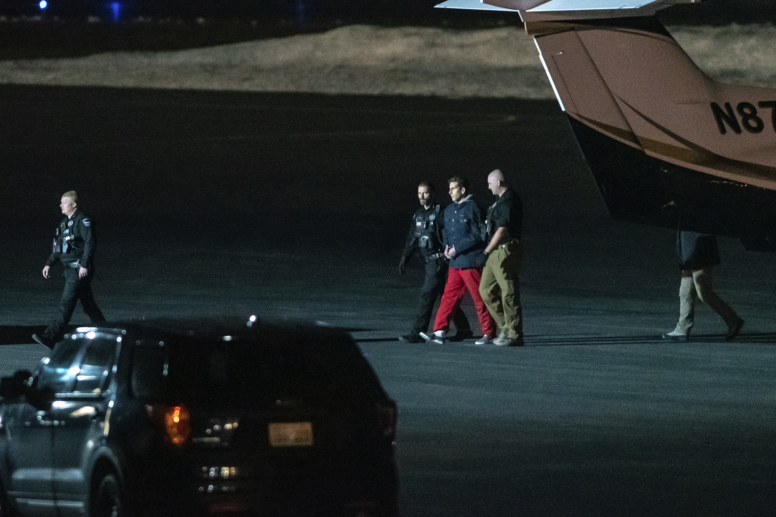 Bryan Kohberger is escorted by law enforcement after arriving at Pullman-Moscow Regional Airport in Pullman, Washington, on Thursday.