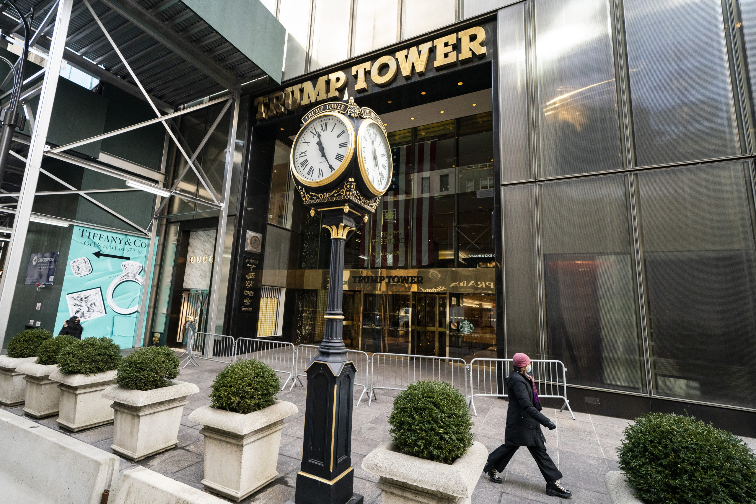 A pedestrian passes security barricades in front of Trump Tower in New York City in 2021. The Trump Organization on Friday was fined $1.61 million, not even enough to buy a Trump Tower apartment.