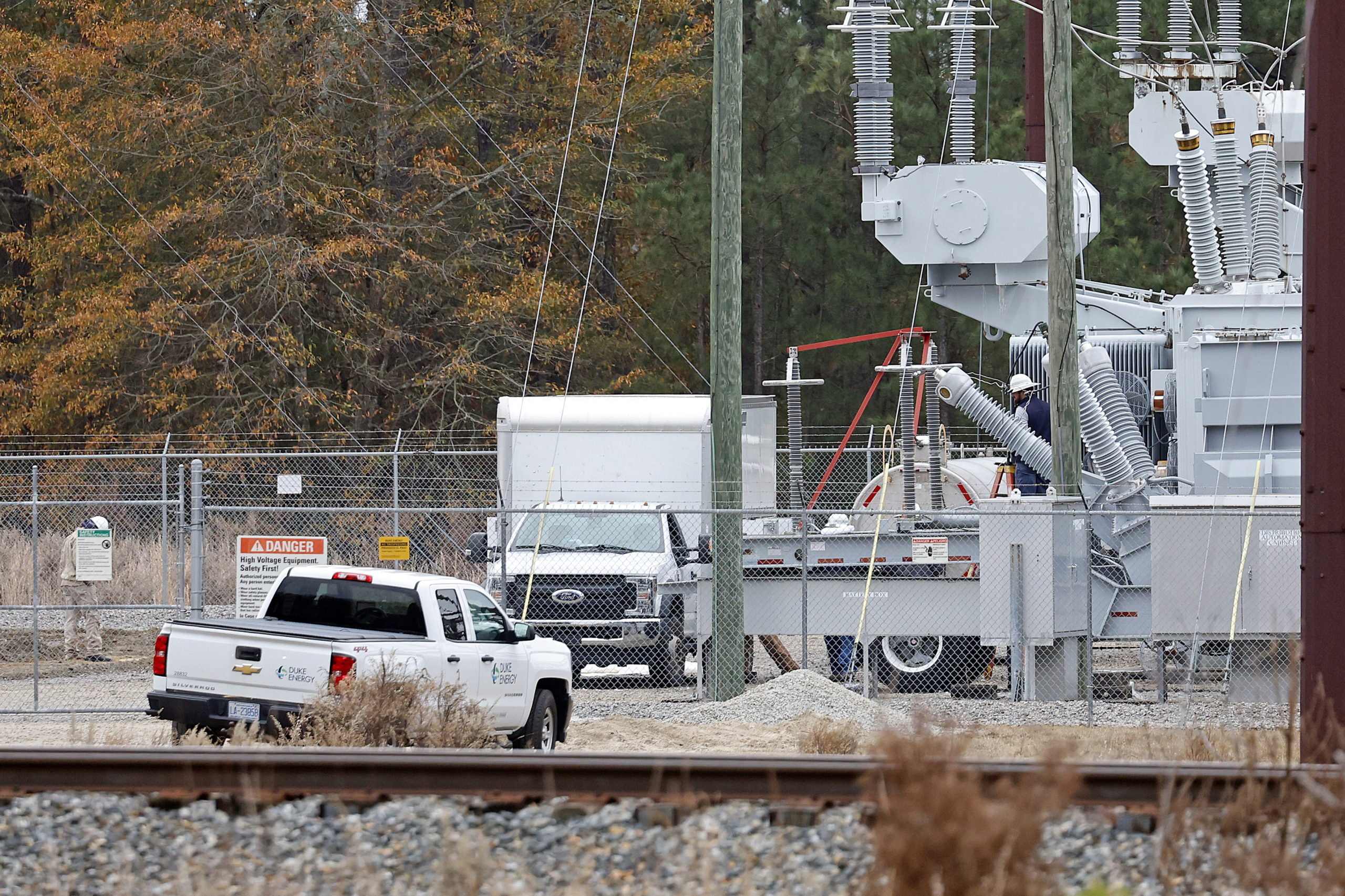 Workers work on equipment at the West End Substation in West End, North Carolina, on Dec. 5, 2022, where a serious attack on critical infrastructure caused a power outage to many around Southern Pines.