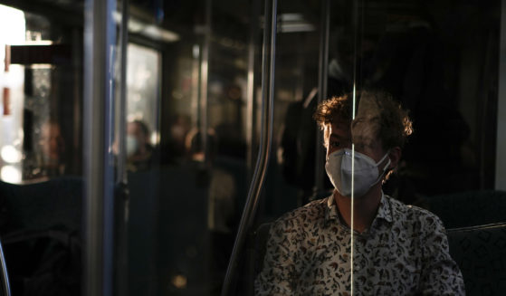 A man wearing a mask travels on a train in Berlin on March 22, 2022.