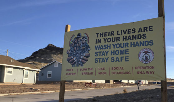 A sign urging safety measures during the coronavirus pandemic is displayed in Teesto, Arizona, on the Navajo Nation on Feb. 11, 2021.