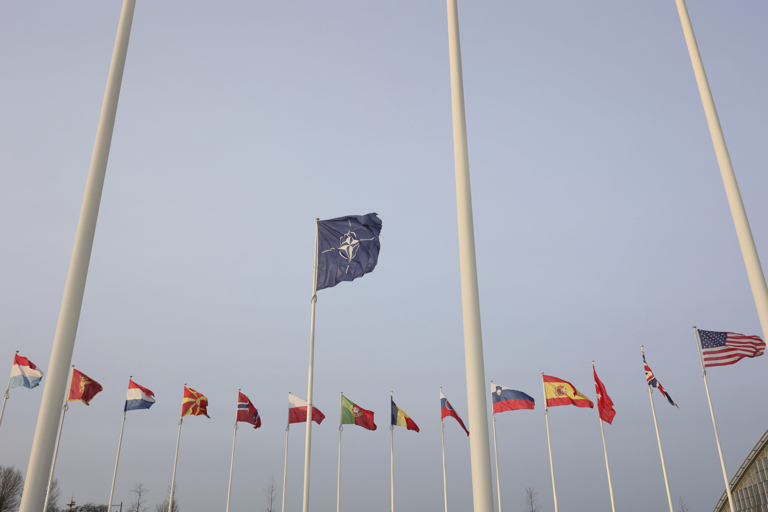 Flags of NATO members fly outside the NATO headquarters ahead of NATO Secretary General Jens Stoltenberg, European Commission President Ursula von der Leyen and European Council President Charles Michel signing a joint declaration on NATO-EU Cooperation at NATO headquarters in Brussels, Belgium, on Tuesday.