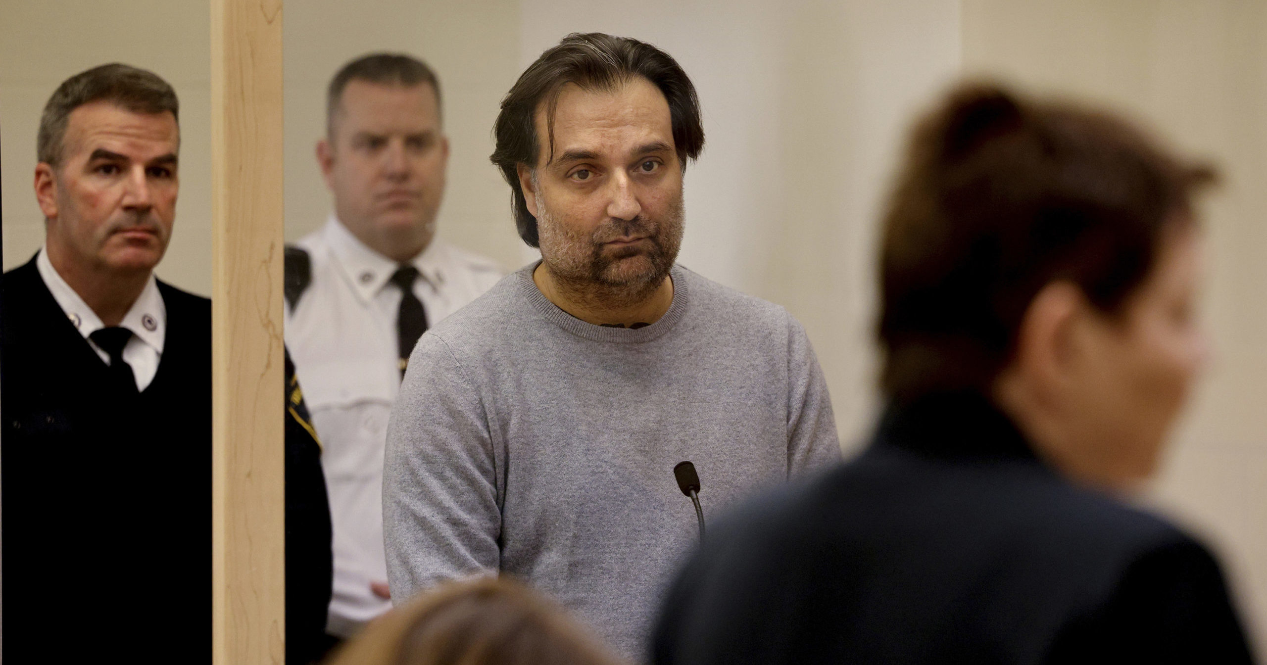 Brian Walshe, center, listens during his arraignment Wednesday at Quincy District Court in Quincy, Massachusetts.