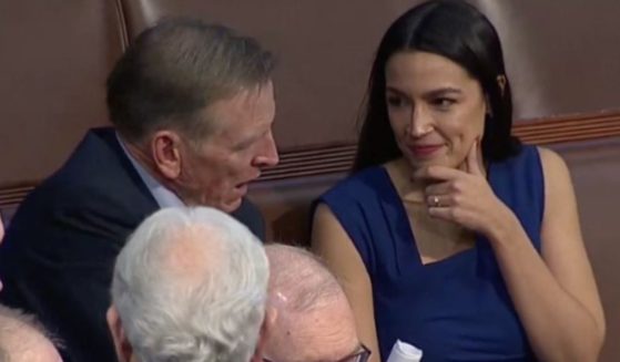 Democratic Rep. Alexandria Ocasio-Cortez, right, was seen smiling and talking with Republican rival Rep. Paul Gosar, left, after the vote for the speaker of the House concluded with no winner.