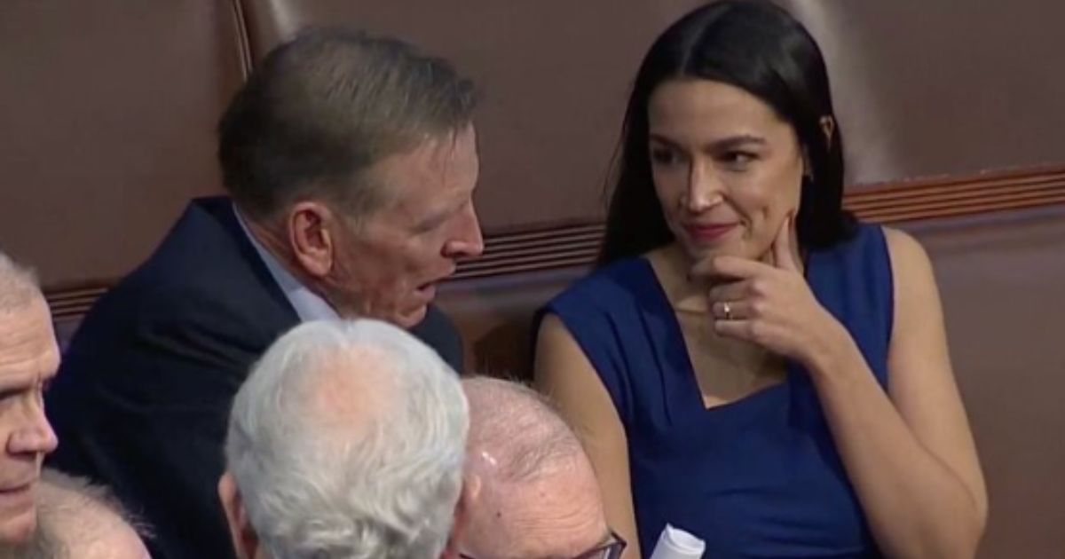 Democratic Rep. Alexandria Ocasio-Cortez, right, was seen smiling and talking with Republican rival Rep. Paul Gosar, left, after the vote for the speaker of the House concluded with no winner.