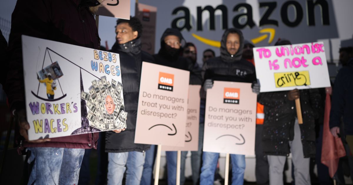 On Wednesday, Amazon workers stand on a picket line during a strike outside an Amazon fulfillment center in Coventry, England.