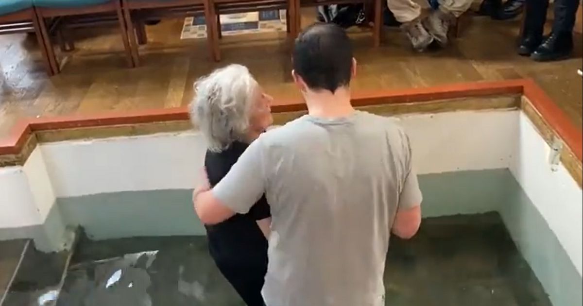 Pastor Regan Blanton King of Grace Baptist Church in the Wood Green district of London baptizes a frail 77-year-old woman named Susan.