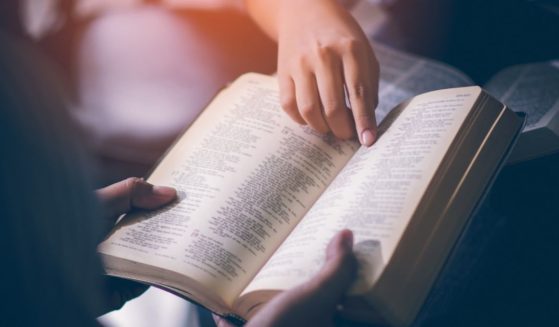 People study the Bible in this stock image.