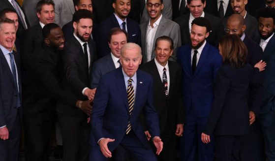 President Joe Biden gestures after rising to his feet during the Golden State Warriors' visit to the White House in Washington on Tuesday.