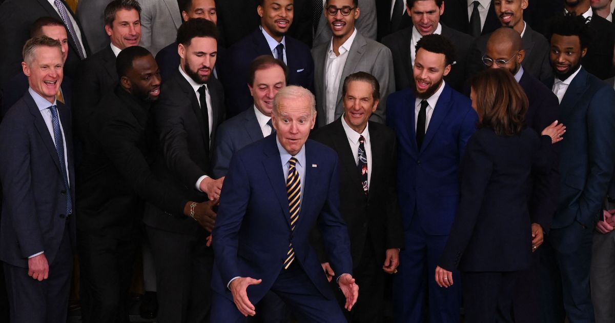 President Joe Biden gestures after rising to his feet during the Golden State Warriors' visit to the White House in Washington on Tuesday.