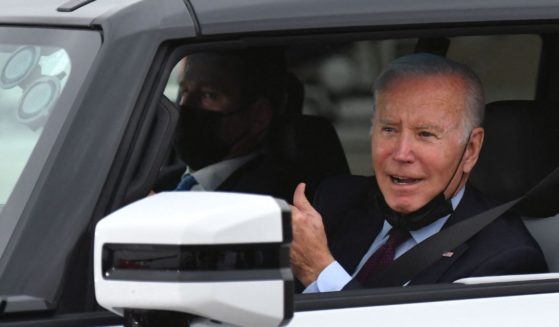 Joe Biden test drives an electric hummer as he tours the General Motors Factory ZERO electric vehicle assembly plant in Detroit, Michigan on November 17, 2021.