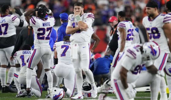 Josh Allen (No. 17) and other Buffalo Bills players react to teammate Damar Hamlin's collapse after making a tackle against the Cincinnati Bengals during the first quarter Monday night at Paycor Stadium in Cincinnati, Ohio.