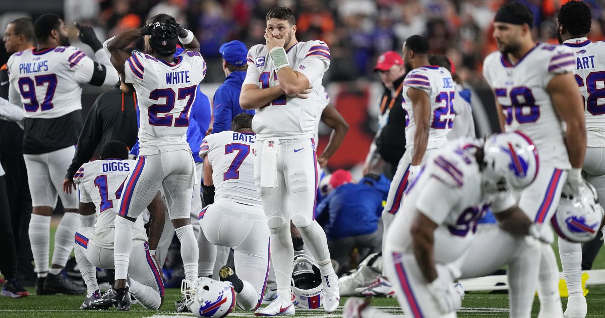 Josh Allen (No. 17) and other Buffalo Bills players react to teammate Damar Hamlin's collapse after making a tackle against the Cincinnati Bengals during the first quarter Monday night at Paycor Stadium in Cincinnati, Ohio.