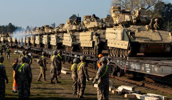 Soldiers from Fort Hood in Texas prepare to unload Bradley Infantry Fighting Vehicles from rail cars as they arrive at the Pabrade railway station north of Vilnius, Lithuania, on Oct. 21, 2019.