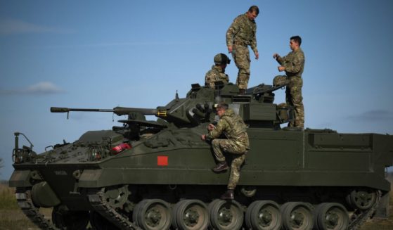 British military personnel are seen on a Warrior armored fighting vehicle during a live fire five-week combat training course with Ukrainian recruits near Durrington, England, on Oct.11, 2022.