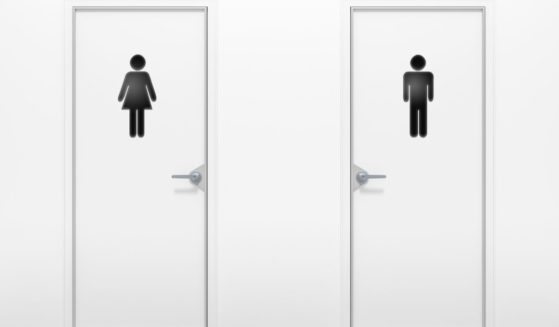 This stock photo shows men and women's restrooms next to each other in a hallway.